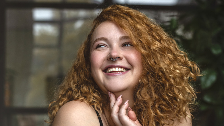 woman with curly hair smiling 