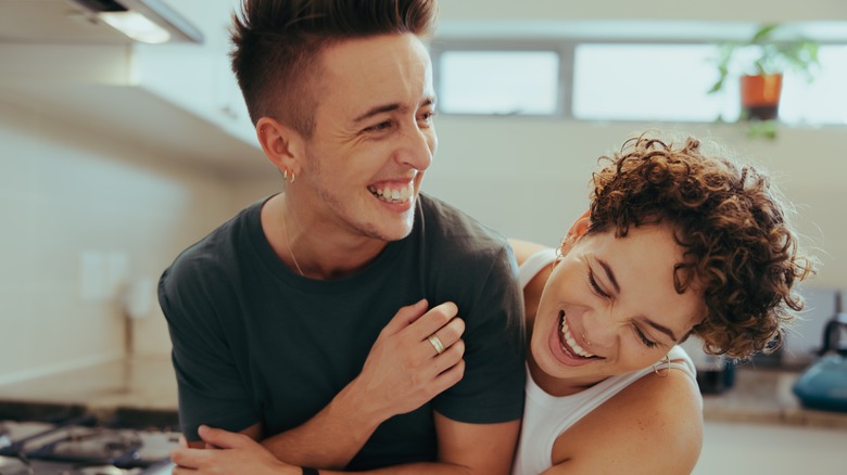 Queer couple laughing