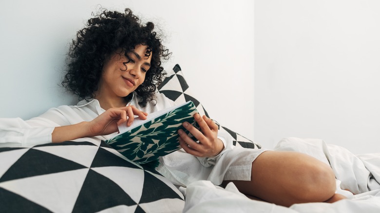 Smiling woman flipping through journal