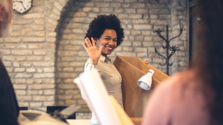 Smiling woman quitting work last day