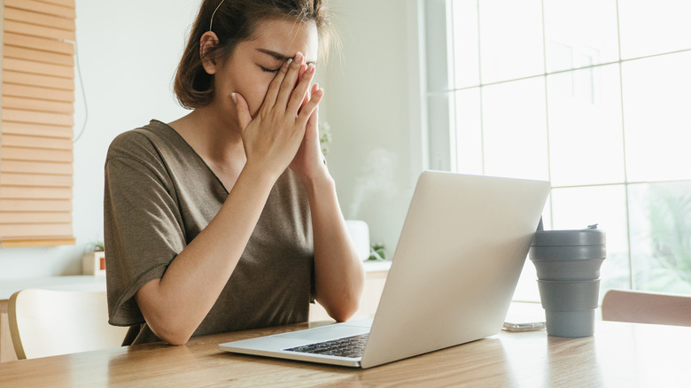 Stressed woman with laptop