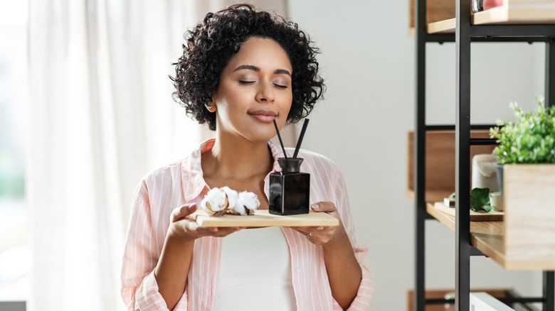 Girl smelling diffuser