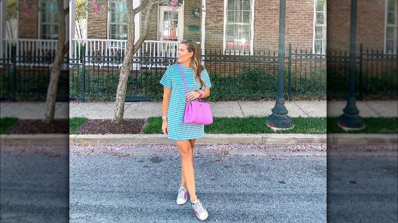 Girl wearing Golden Goose sneakers with a dress.
