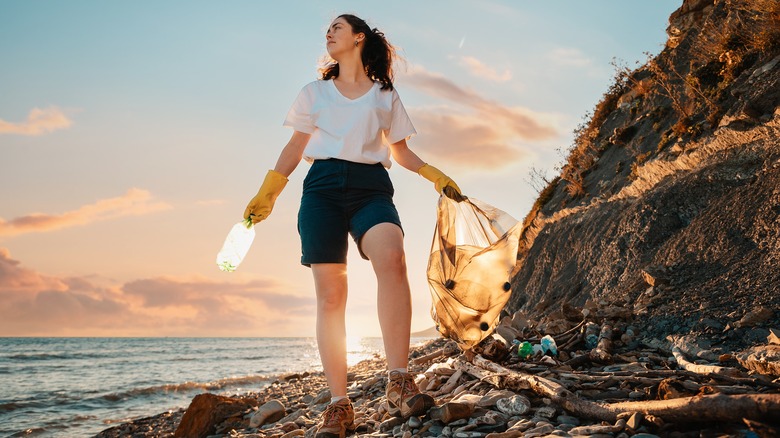 Woman cleaning ocean pollution
