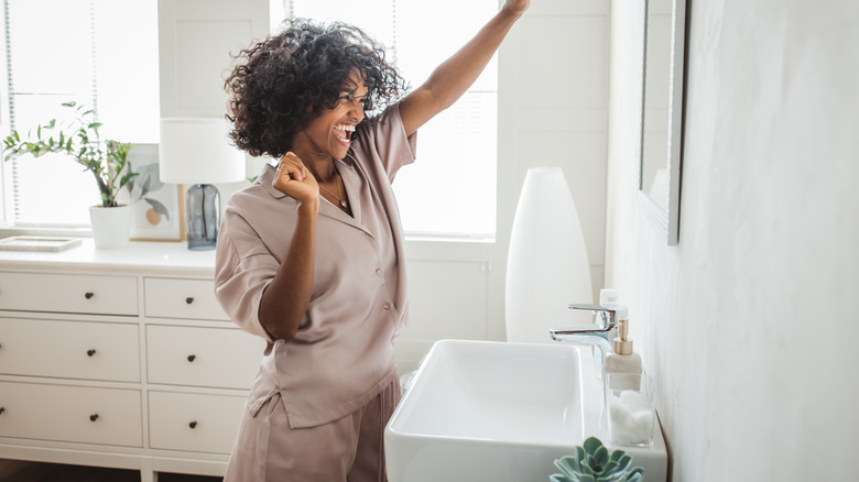 Happy woman staring bathroom