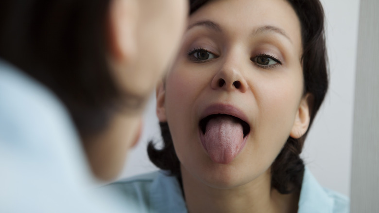 Woman sticks tongue out