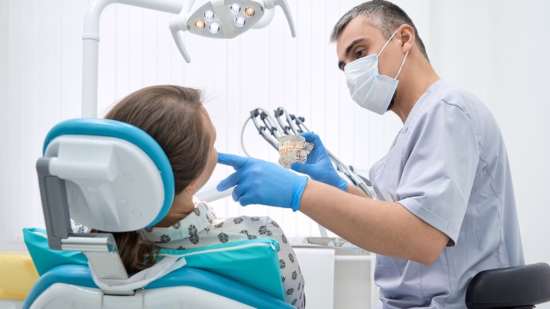 Orthodontist examines woman's jaw
