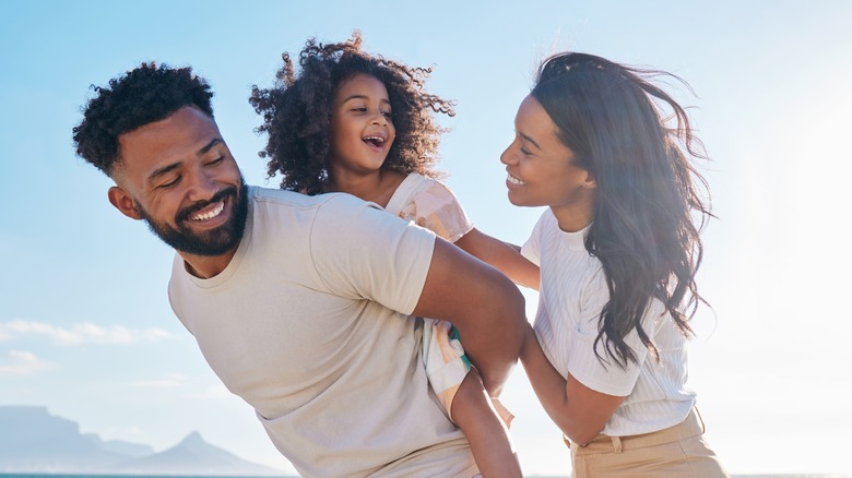 Smiling young couple with child