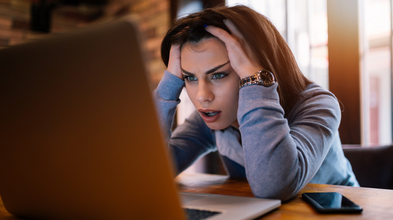 frustrated woman looking at laptop