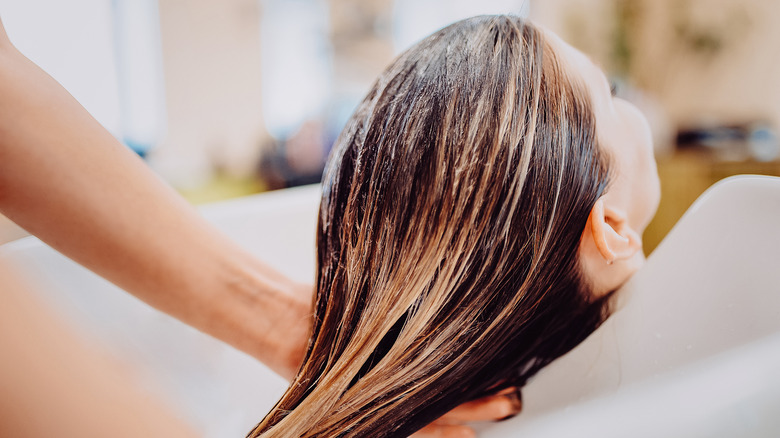 woman having hair washed at salon