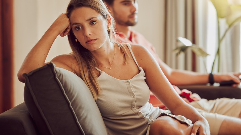 Unhappy couple on sofa