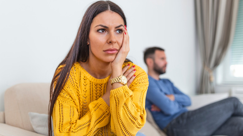 Frustrated woman faces away from partner