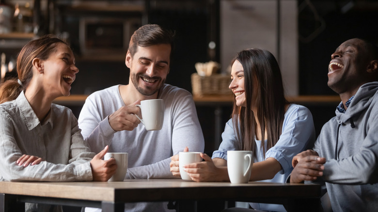 Friends drinking coffee and laughing