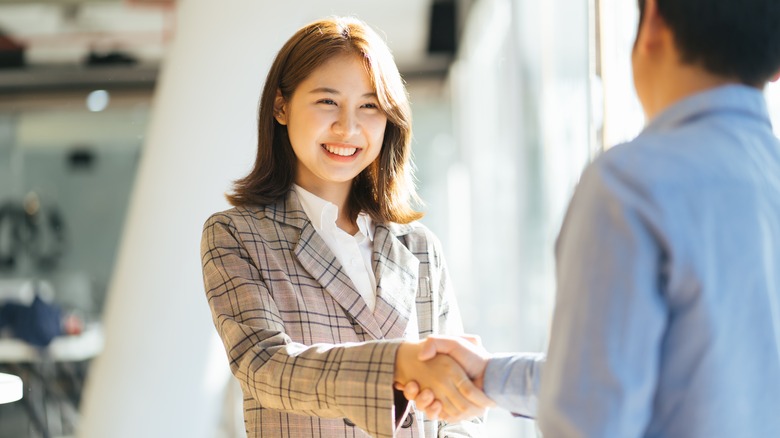 Business woman shaking hands