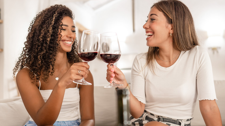 smiling women drinking wine