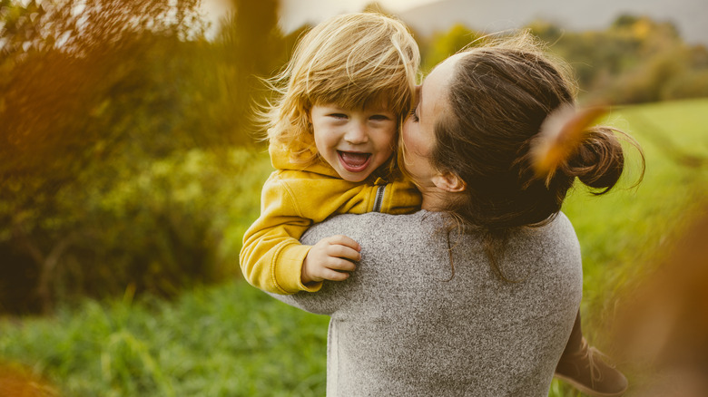 Mother and smiling child outside