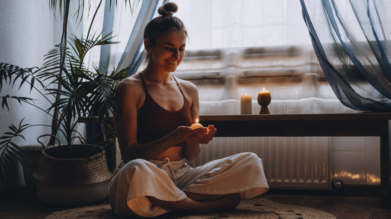 woman smiling at candle 