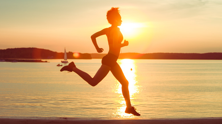 Woman running at sunset