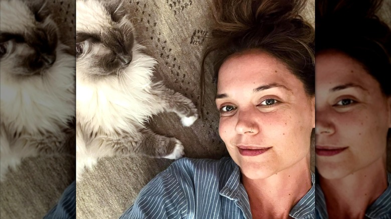 Katie Holmes posing beside her cat without any makeup on.