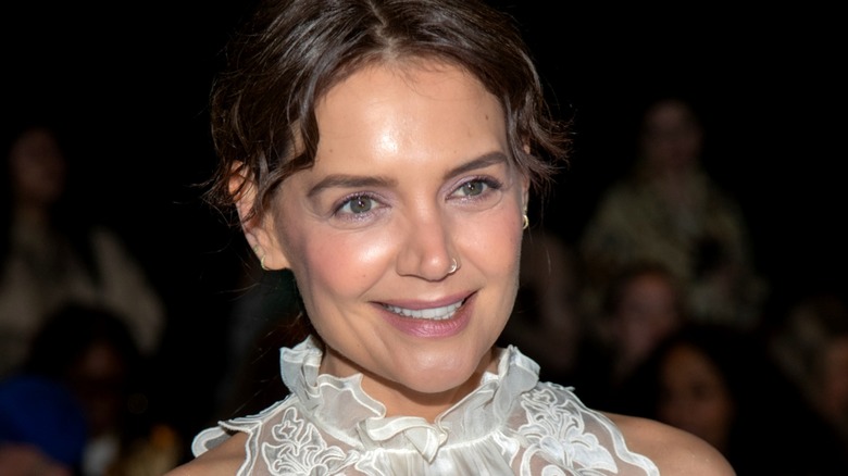 Katie Holmes wearing natural makeup at an Ulla Johnson fashion show in 2024.