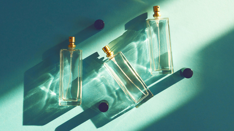Three perfume bottles arranged under sunlight