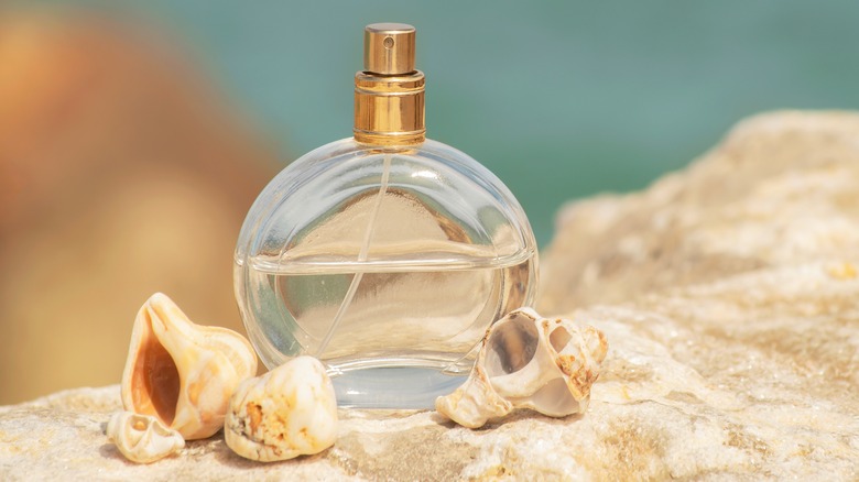 Round perfume bottle on beach setting