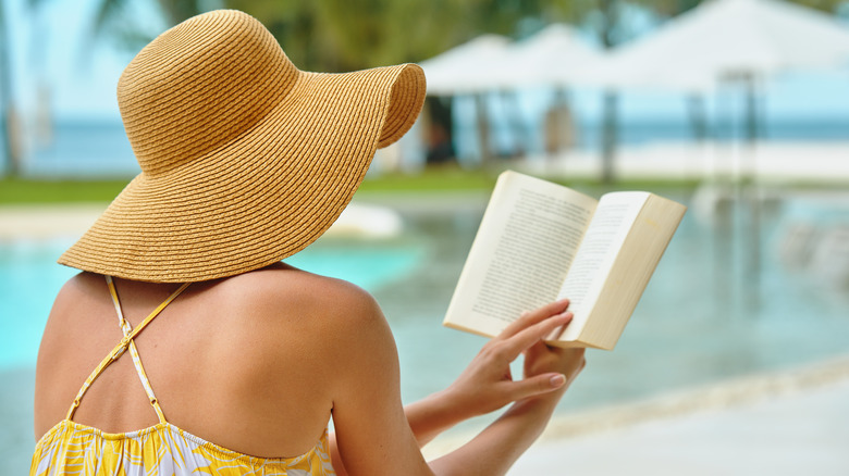 Woman reading by pool