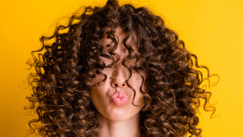 curly-haired woman pouting lips