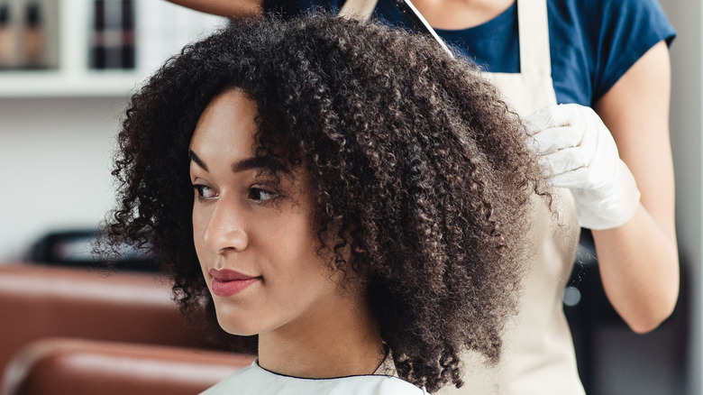 woman getting curly cut