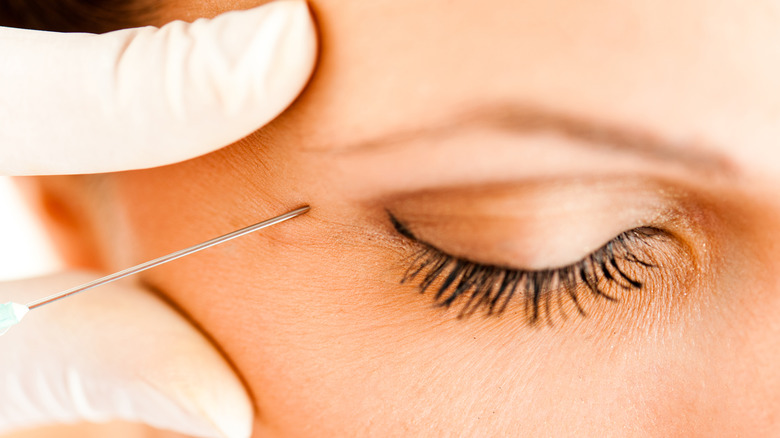 Woman getting injection near eye