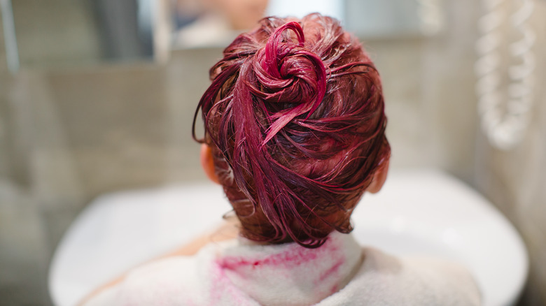 A woman dying her hair red