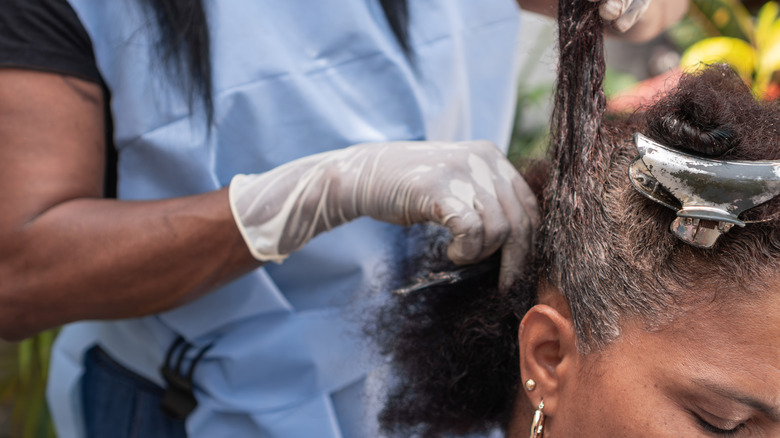 A woman getting her hair dyed