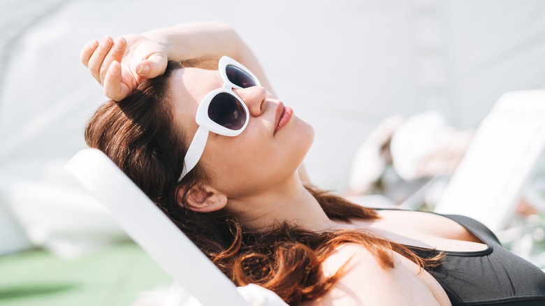 Woman sunbathing on a chair