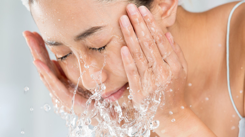 Woman washing her face