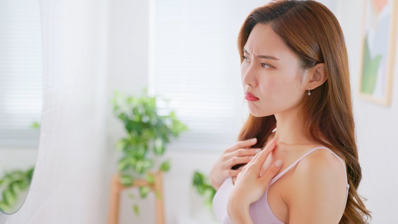 Woman looking at her chest