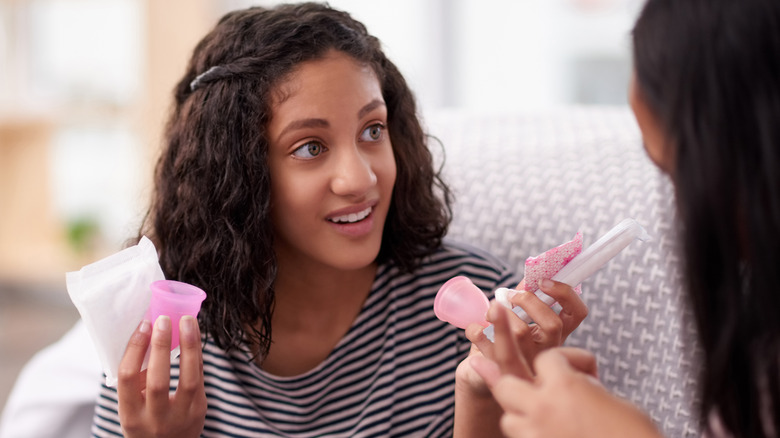 girl holding feminine hygiene products