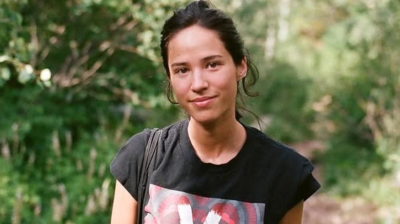 Kelsey Asbille posing in the forest without makeup.