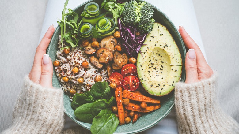 person with plate of healthy foods