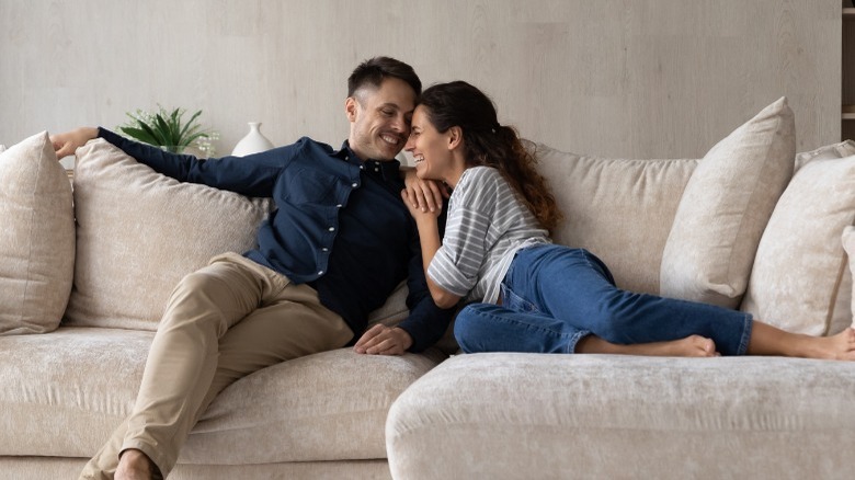 Couple laughing on the couch