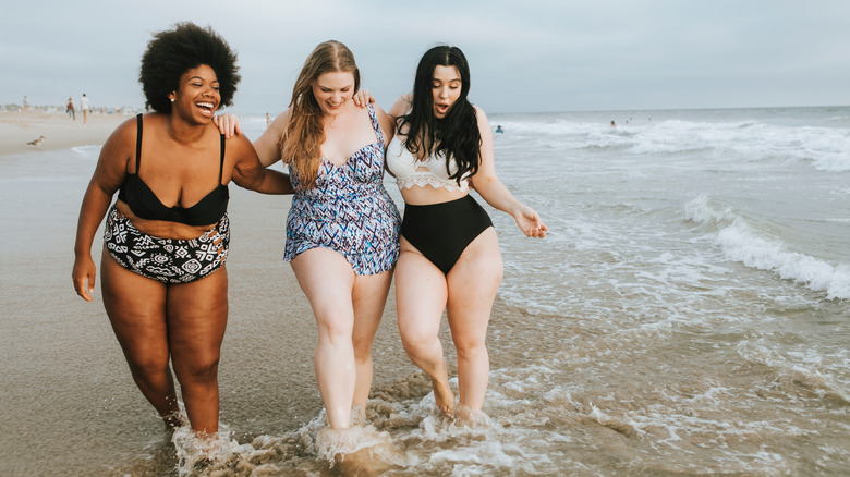 Three women laughing beach