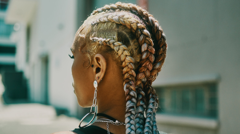 woman braiding her hair 