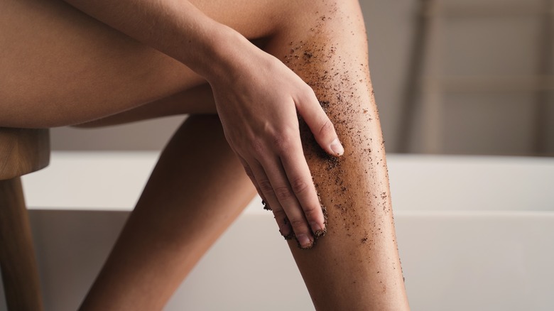 Person exfoliating their skin.