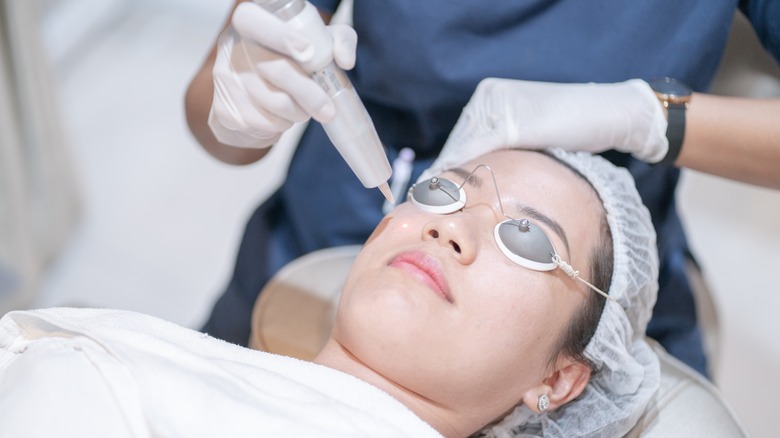 Woman getting laser skin treatment