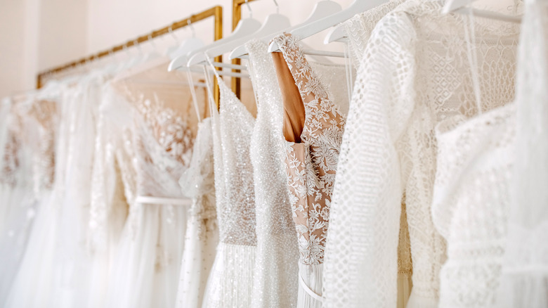 wedding dresses hanging on rack