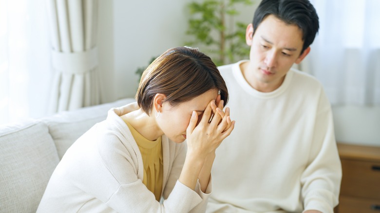 Upset woman is consoled by family member 
