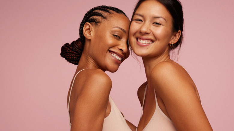 Two smiling women with glowing skin