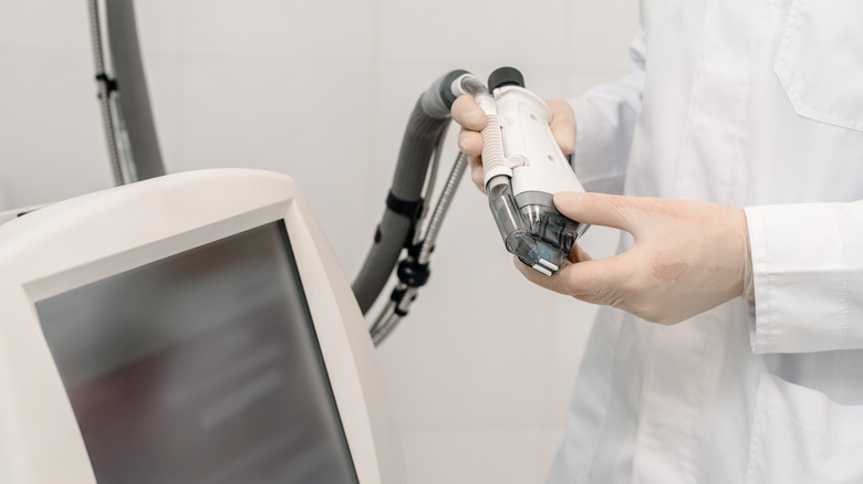 Dermatologist holding a laser machine