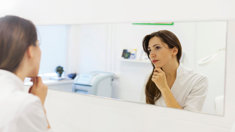 woman looking at herself in a mirror 