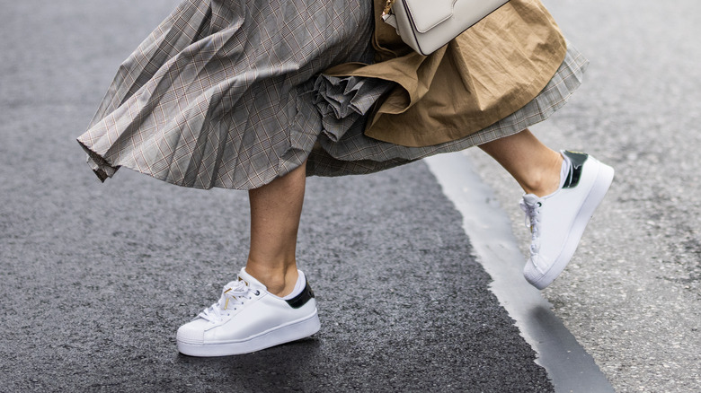 Business woman wearing long skirt and sneakers