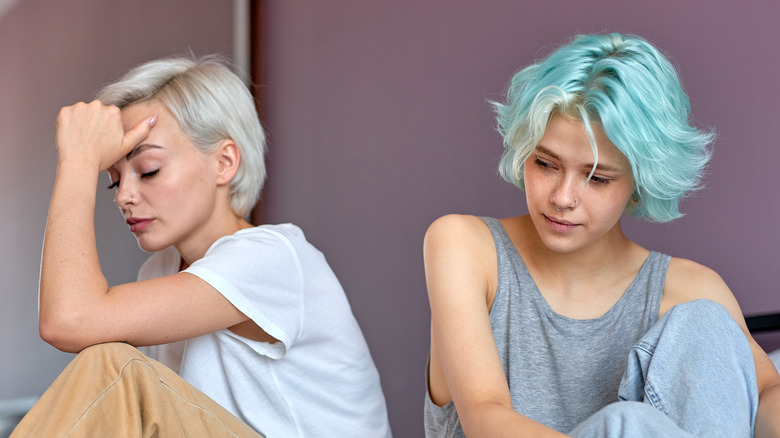 two women in bed upset